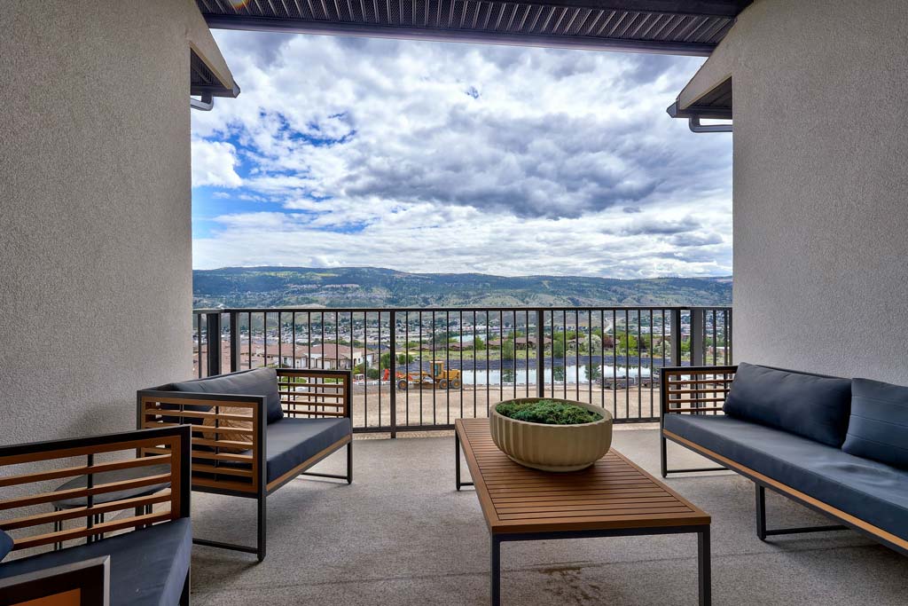 Modern kitchen with wood cabinetry, island seating, and stainless steel appliances