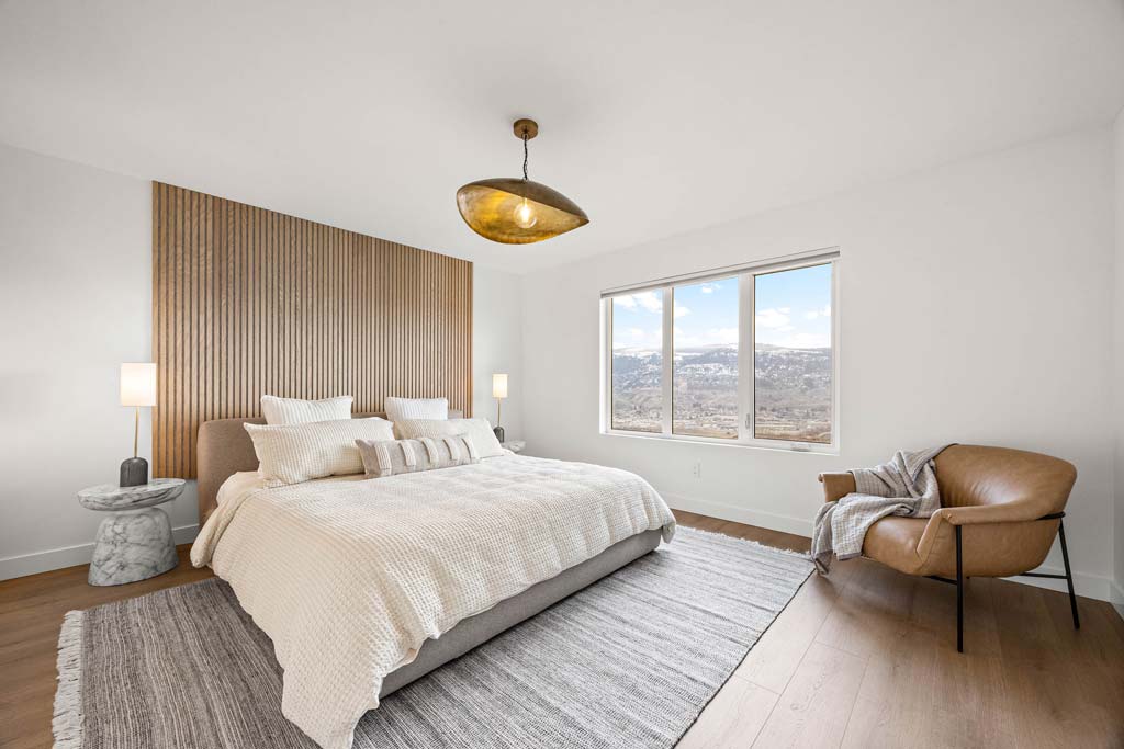 Open-concept living room with kitchen island, seating area, and mountain views
