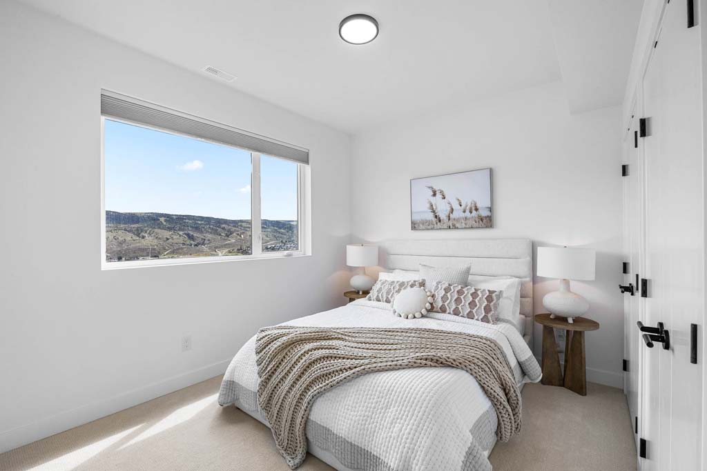 Kitchen and living area with island seating, pendant lighting, and large window views